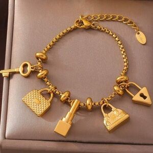 Gold Plated Stainless Steel Charm Bracelet – Key, Lock, Lipstick & Purse Design